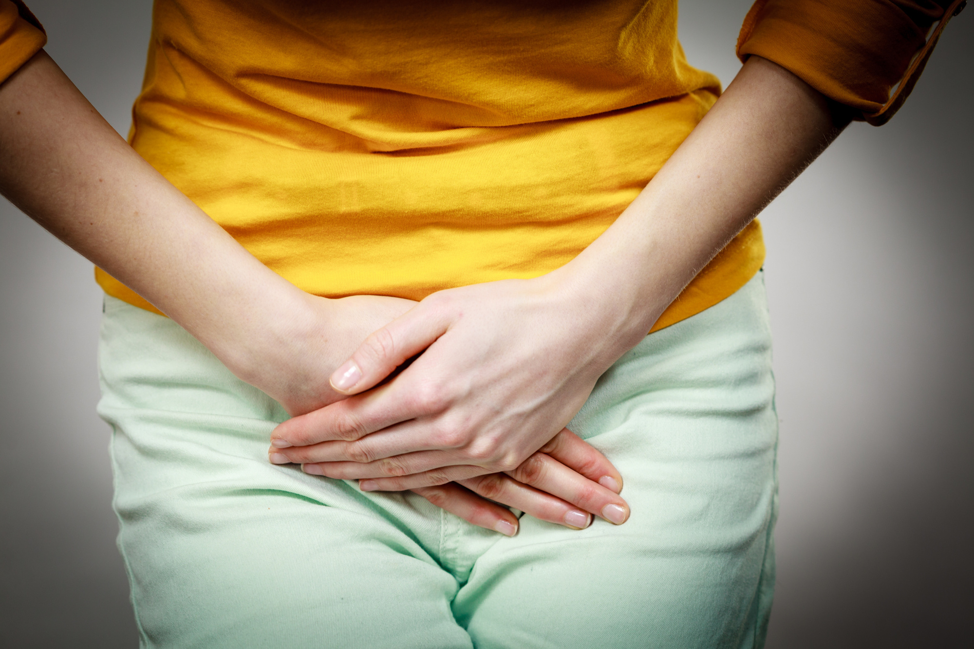 Part of body young sick woman with hands holding pressing her crotch lower abdomen. Medical or gynecological problems, healthcare concept