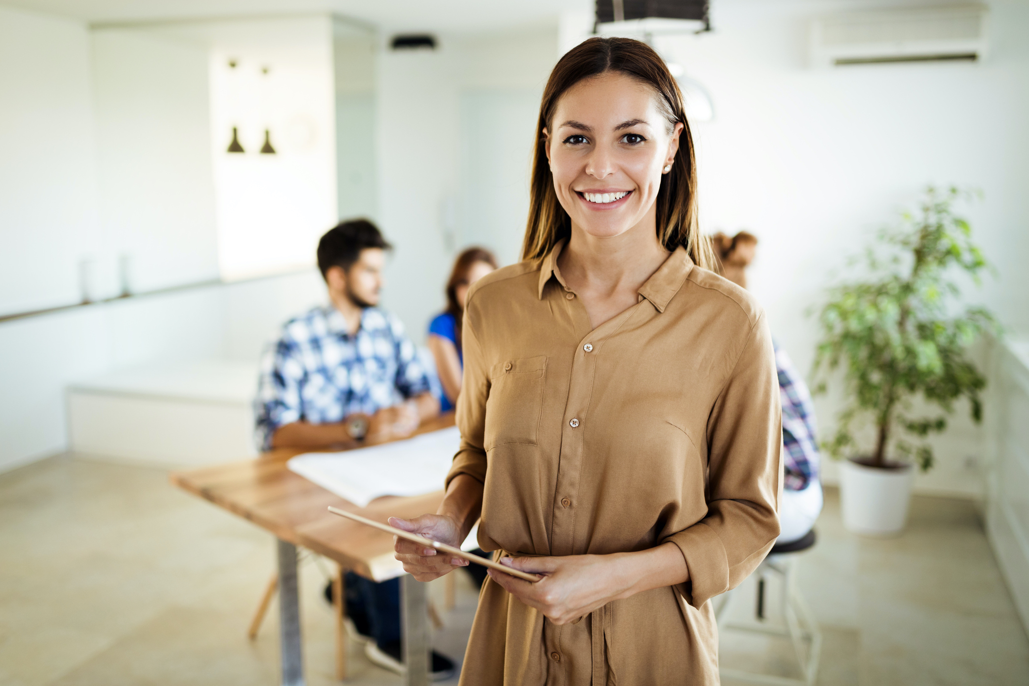 Businesswoman holding tablet at conference tablet having company meeting